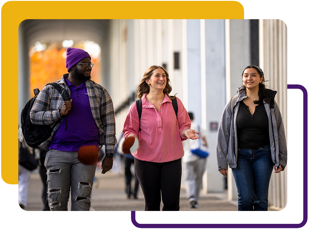 Three students walking together on campus.