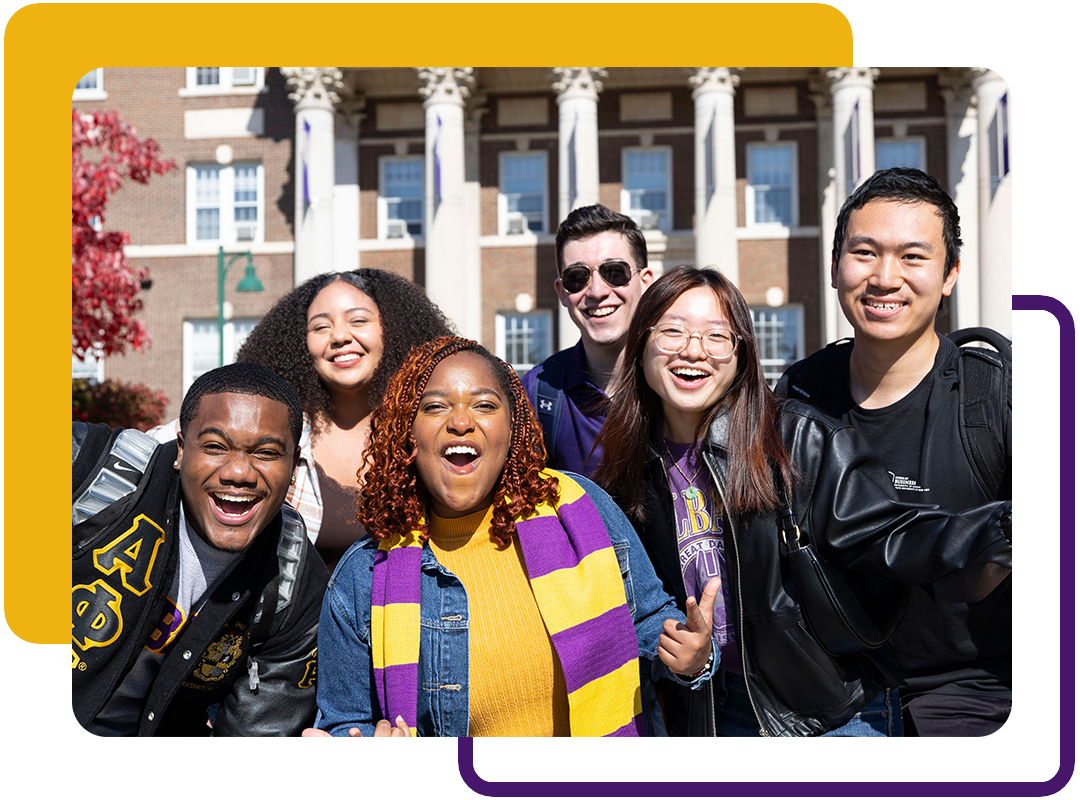 A group of students posing outside on campus.