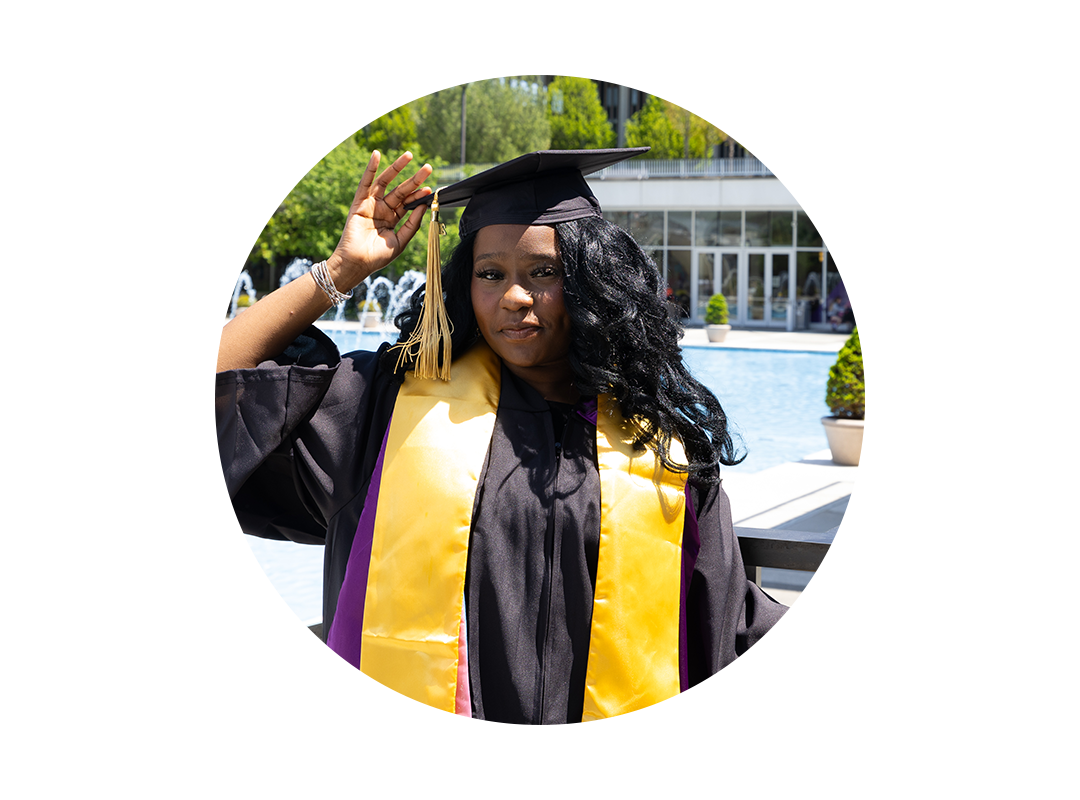 A student wearing a graduation cap and gown.